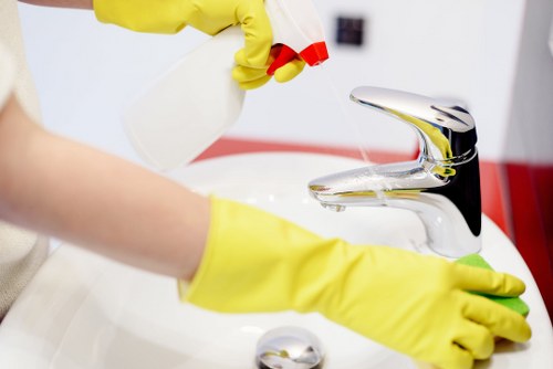 Team member checking cleaning chemicals and equipment before use